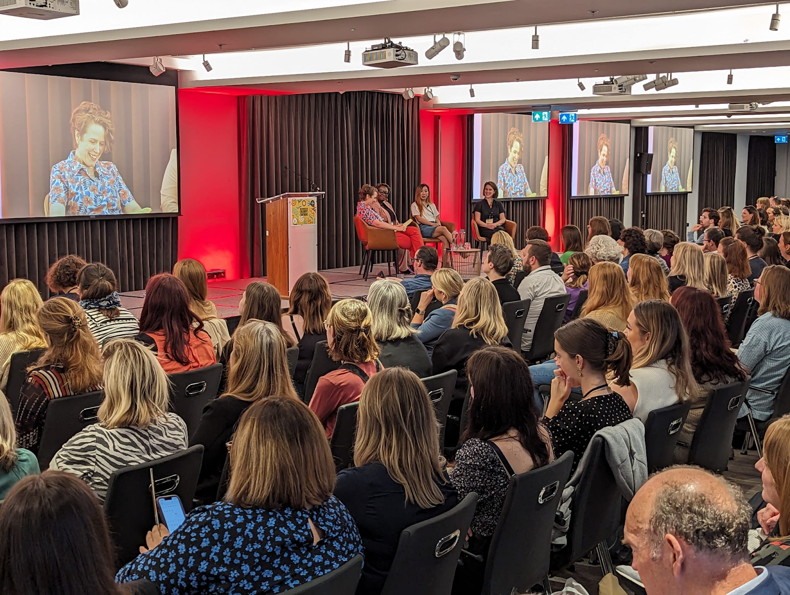 A photo of the bookseller conference during my panel, where I'm reading my speech because I don't know how people memorise that much text.